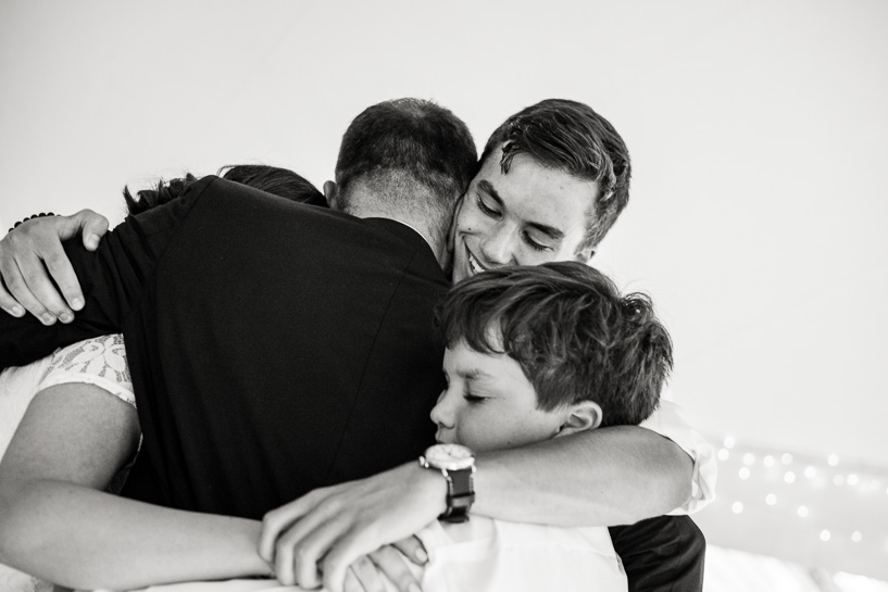 Denver wedding photojournalist captures groom hugging his kids