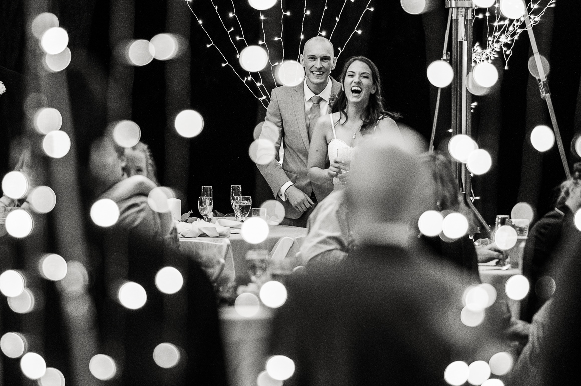 Denver bride and groom laugh at a wedding venue near Fort Collins.