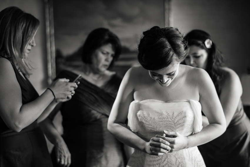 Bride clasps hands in the Presidential suite at the Warwick Hotel while preparing for wedding.