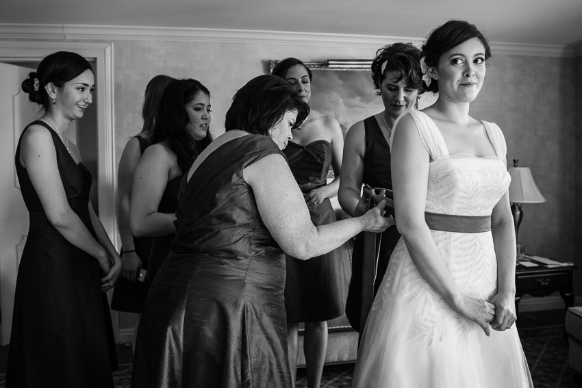 Finishing touches of bride getting ready in the Presidential Suite of the Denver Warwick Hotel.