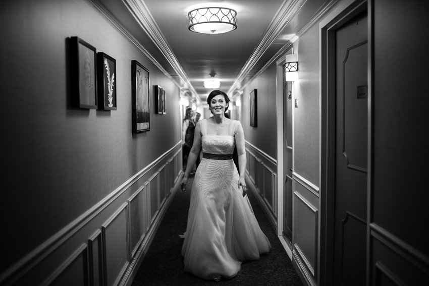 Bride walks down hallway at the Denver Warwick Hotel.