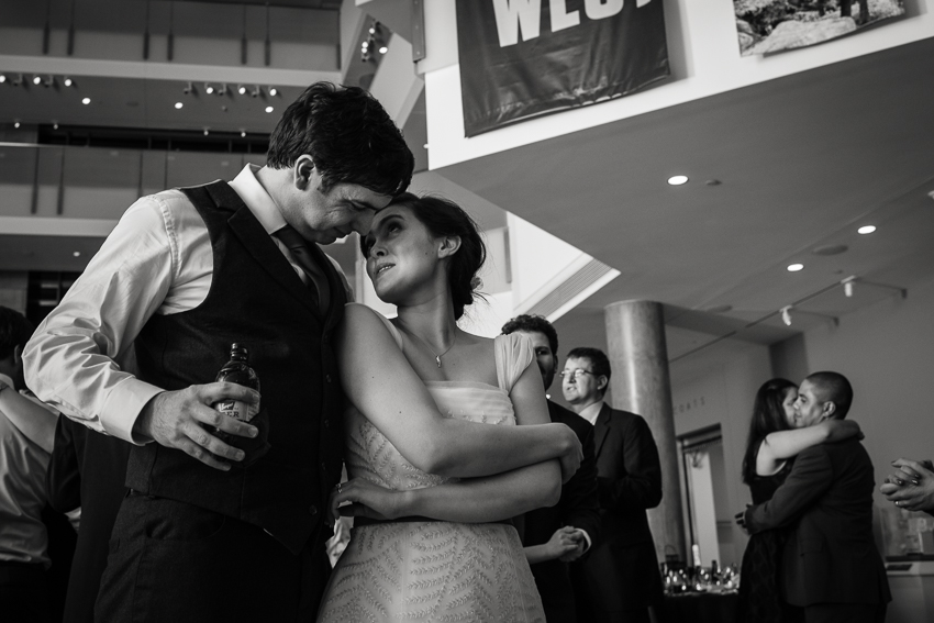 Bride and groom embrace on the dance floor of the History Center Colorado in Denver.