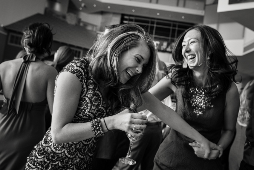 Women dancing during a reception by Denver wedding photographer.