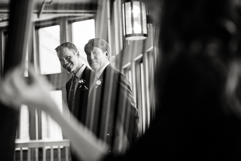 Officiant and groom listen to harpist before a wedding at the Spruce Saddle Lodge in Beaver Creek.