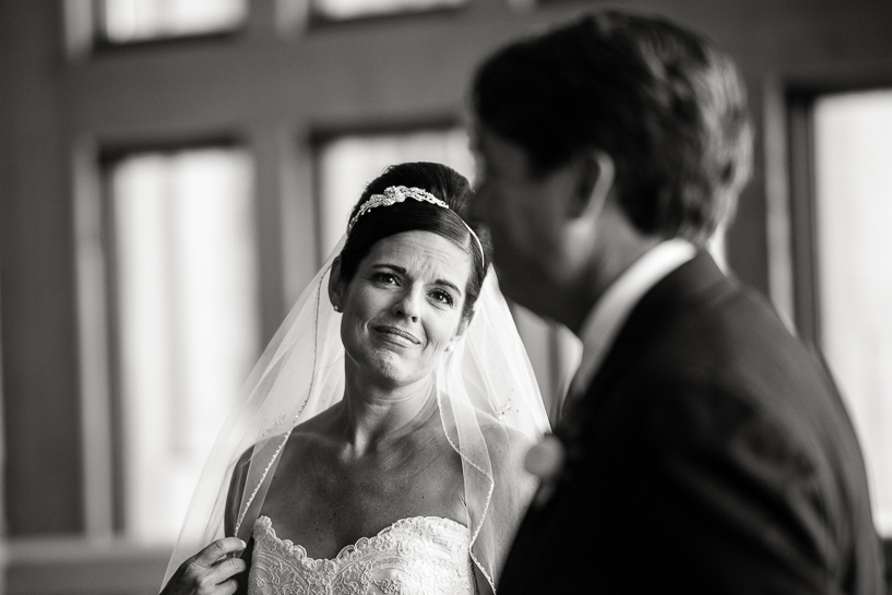 Bride at Spruce Saddle Lodge wedding in Beaver Creek listens to groom during ceremony.