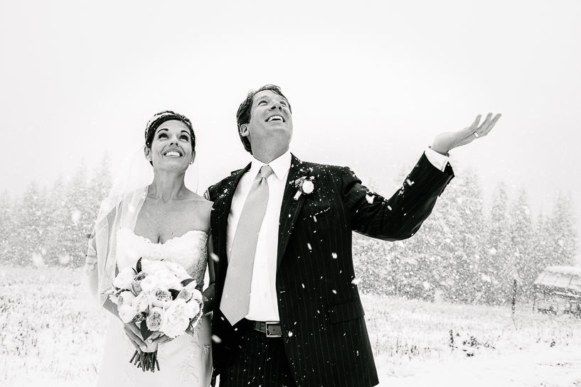 Bride and groom in snowstorm at Spruce Saddle Lodge wedding.