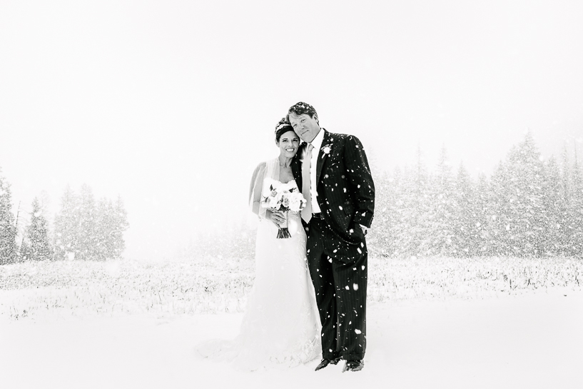 Bride and groom in sudden snowstorm at Spruce Saddle Lodge in Beaver Creek.
