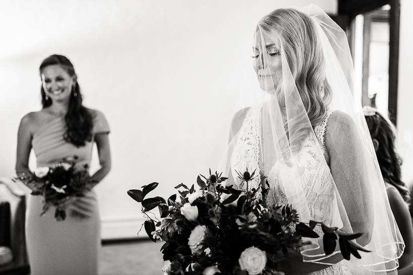 A bride closes her eyes with emotion while getting ready by Denver wedding photographer at The Villa Parker