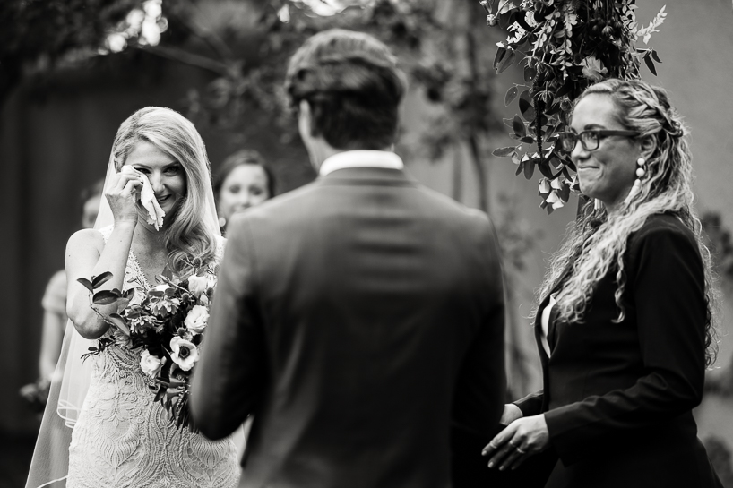 Bride wipes her eyes during a tearful moment in a ceremony by Denver wedding photojournalist at The Villa Parker.