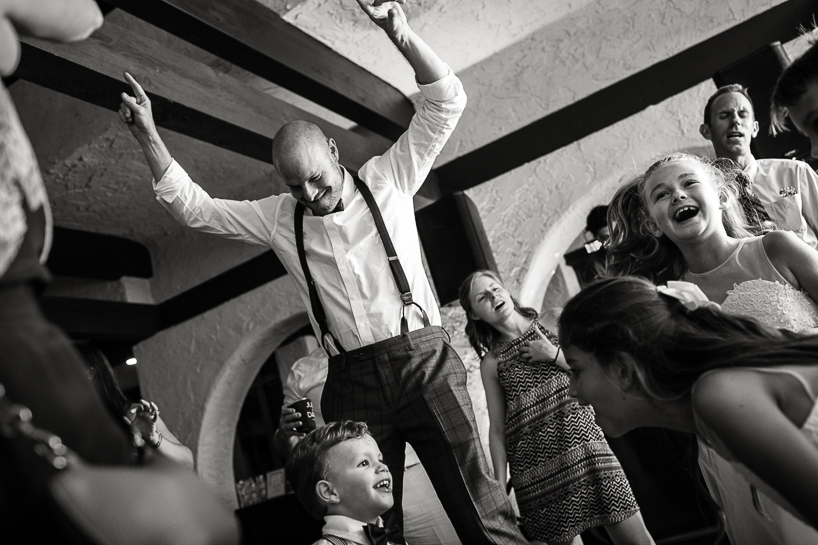 Denver wedding photojournalist at The Villa Parker captures dance floor craziness during reception.