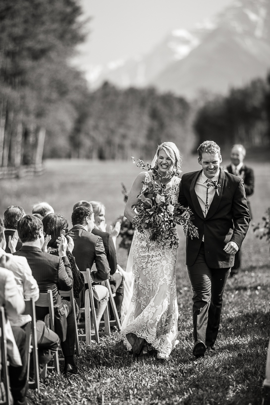 Couple at the end of an Aspen wedding ceremony by Denver wedding photojournalist.