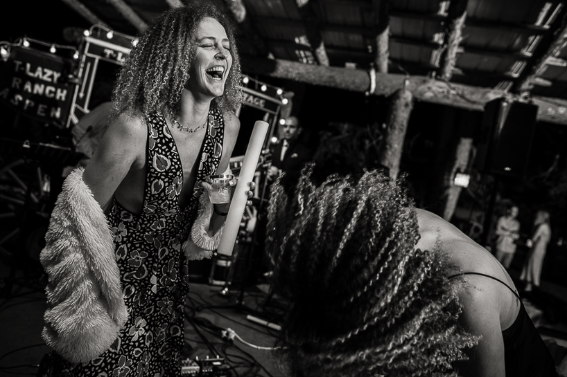 Women laughing on the dance floor of a wedding reception in Aspen, Colorado.