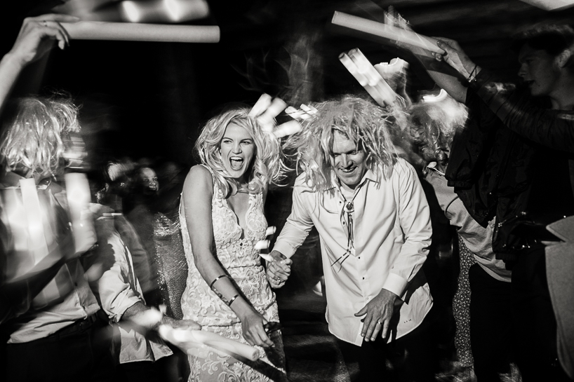 Bride and groom run through nightsticks during their departure from a country wedding near Aspen.