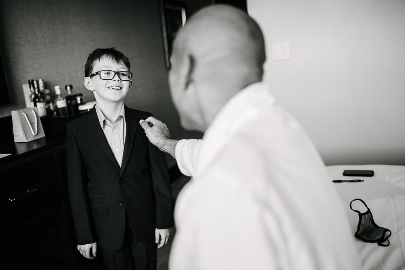 Groom with bride's son while getting ready for Ramble Hotel wedding in Denver.