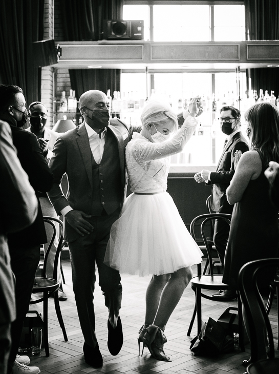Bride and groom dance up the aisle before a Ramble Hotel wedding ceremony, by Denver wedding photojournalist.