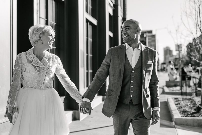 Bride and groom take a walk in the RiNo neighborhood of Denver after their wedding at The Ramble Hotel.