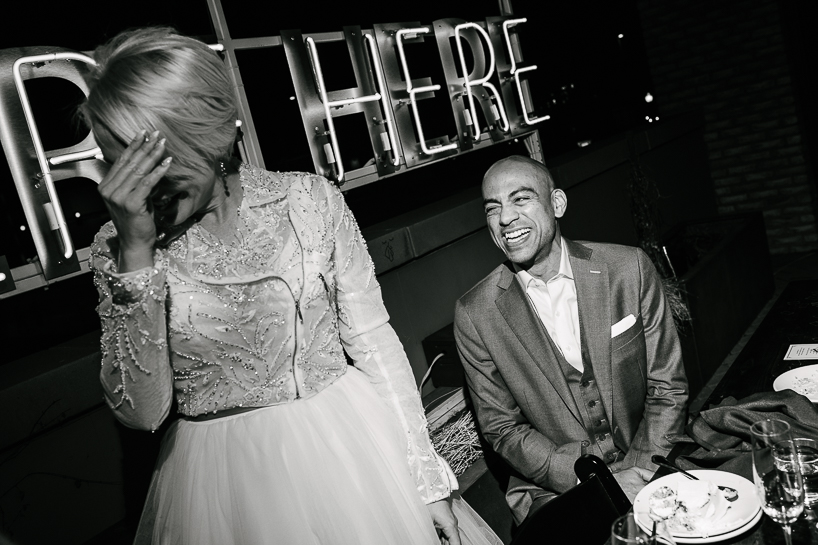 Denver wedding photojournalist captures a light moment at a downtown wedding reception.