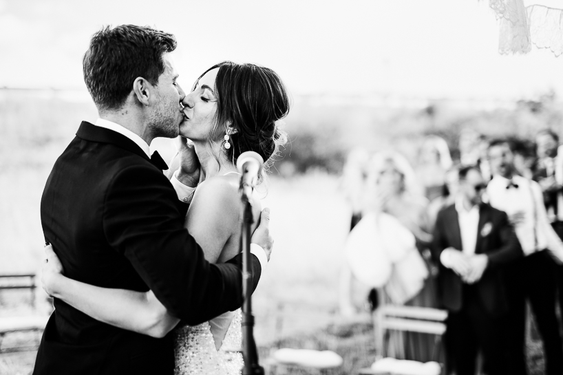 Denver wedding photographer captures kiss at the end of the ceremony at Black Cat Farm outside Boulder.