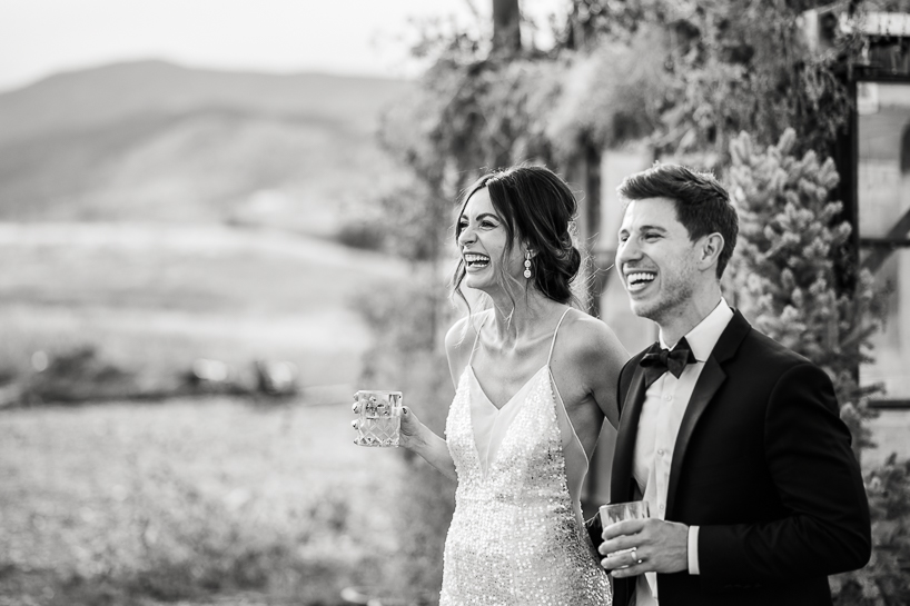 Bride and groom greet guests at Black Cat Farm wedding reception as captured by Denver wedding photographer.
