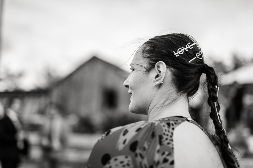 Woman with hair clip reading "love" at Boulder wedding.