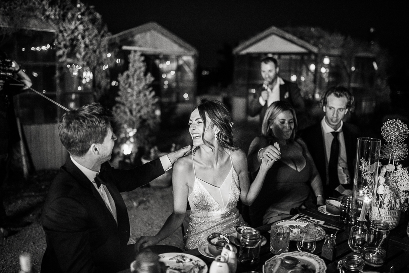 Denver wedding photographer captures bride and groom laughing at Boulder wedding reception.