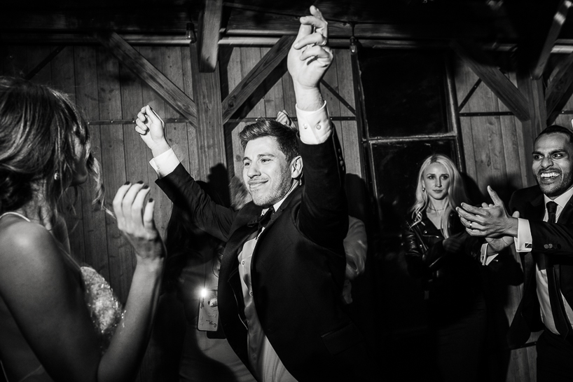Denver wedding photojournalist captures groom dancing at a country wedding outside Boulder, Colorado.