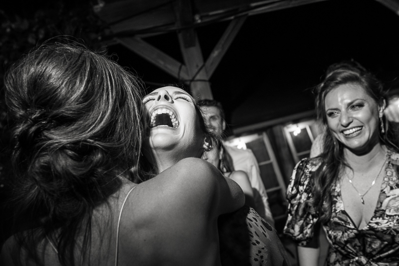 Women laugh on wedding dance floor at a Boulder wedding venue.