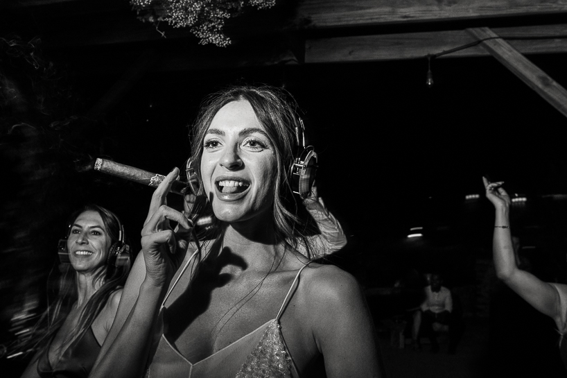 Bride smoking cigar at wedding.