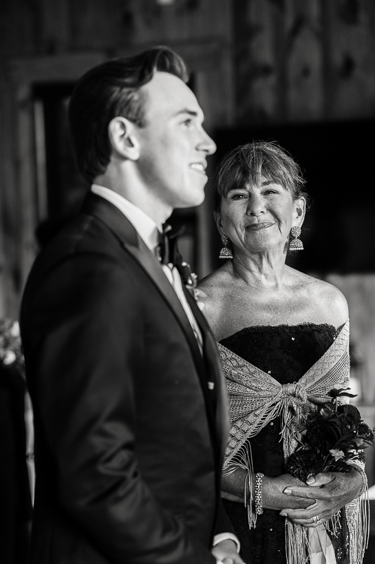The mother of a groom looks at her son before a wedding ceremony.