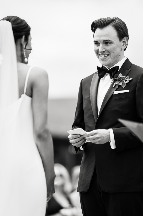 Black and white photo of a groom reading his vows during a Colorado mountain wedding.