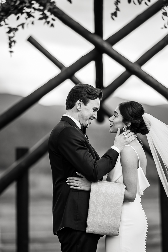 Colorado bride and groom gaze at each other following their Winter Park wedding ceremony.