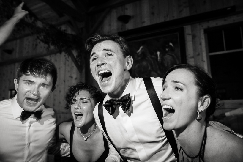 Groom and friends singing on the dance floor of a Colorado mountain wedding at Devil's Thumb Ranch in Winter Park.