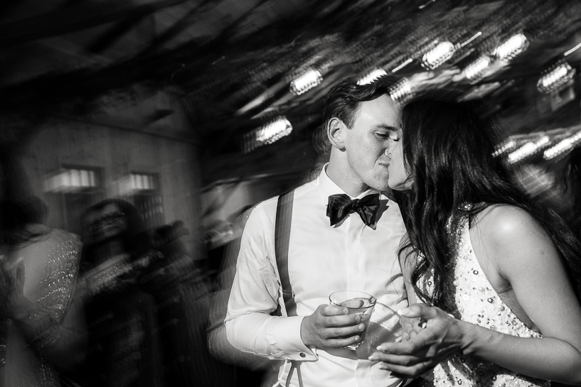 Bride and groom kissing on the dance floor of a Devil's Thumb Ranch wedding at the end of their reception.